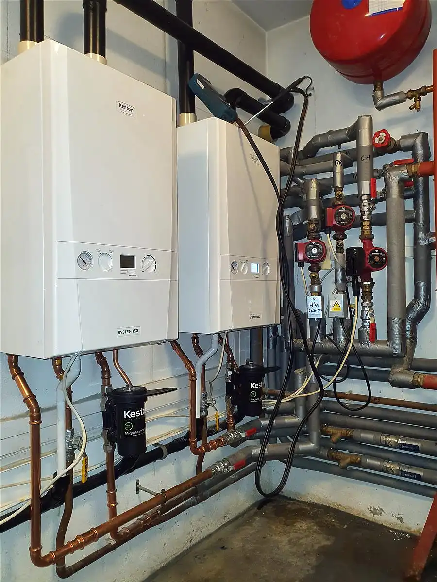 Set of Gas Boilers and copper pipes installed on the wall.